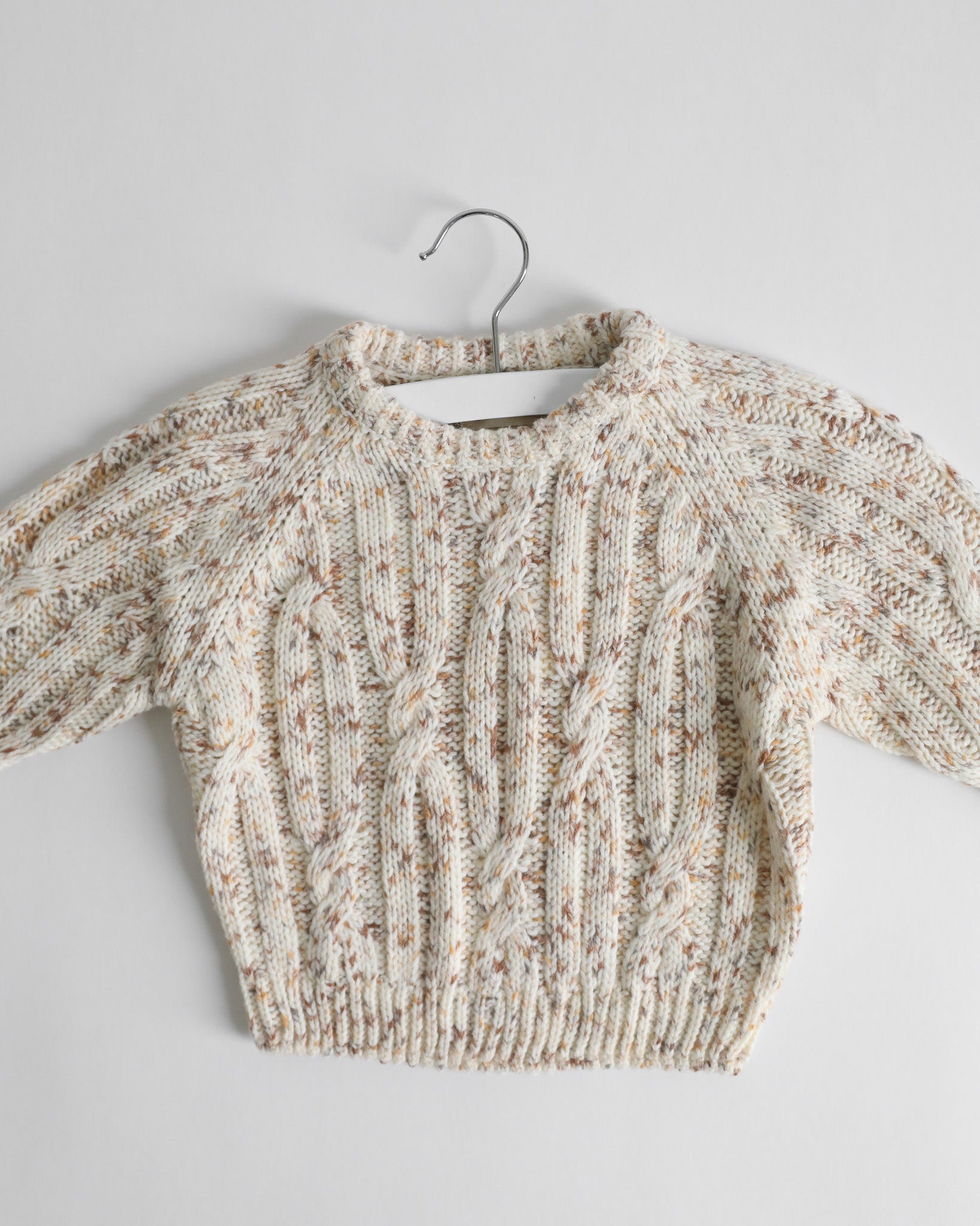 SPECKLED CABLE-KNIT SWEATER